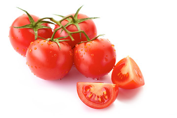 Bunch of wet tomatoes with slices isolated on white background