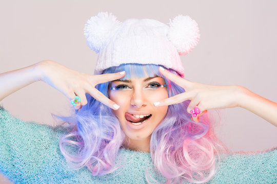 Modern young woman with pastel pink and blue hair and beanie