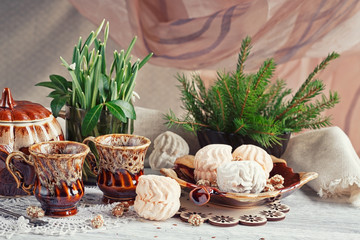 coffee cups with a zephyr, candies and snowdrops