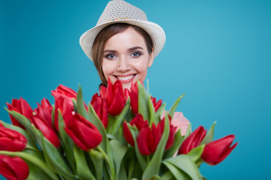 Young beautiful woman studio portrait with tulip flowers