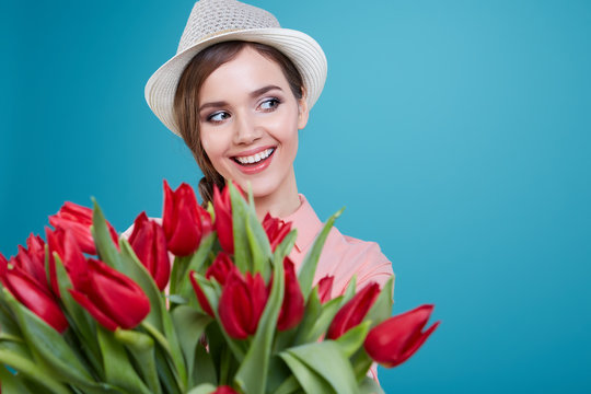 Young beautiful woman studio portrait with tulip flowers