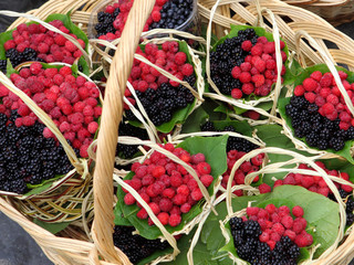 Ripe raspberries and brambles in basket