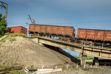 Destroyed bridge with wagons