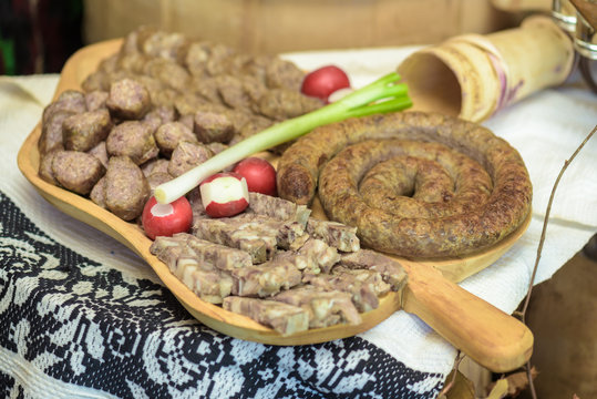 Appetizers with greaves, sausages, specialty pork on wooden  pla