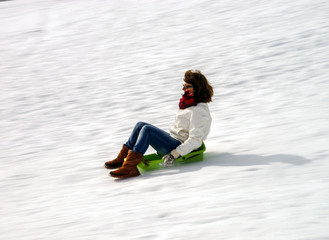 Woman running on sleds from  the hill