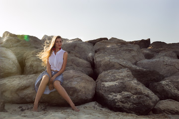 Girl sitting at the rocks