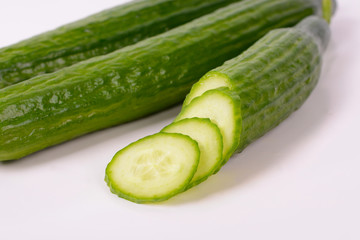 Cucumber and slices isolated over white background