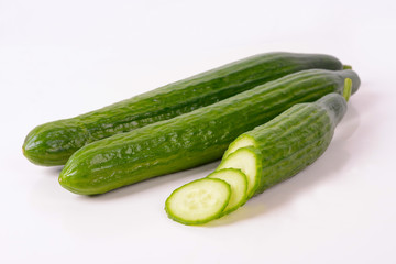 Cucumber and slices isolated over white background