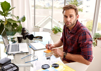 young aduld businessman looking at camera while working