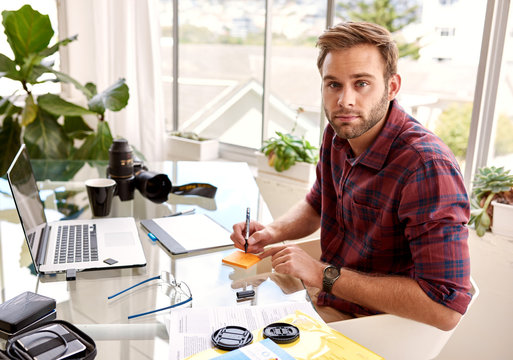 young aduld businessman looking at camera while working