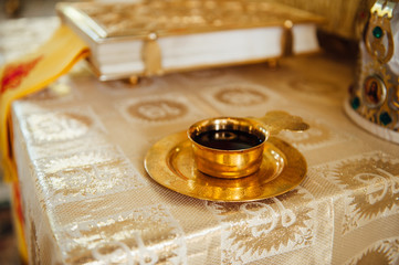 Wedding table priest with the Bible, a crown