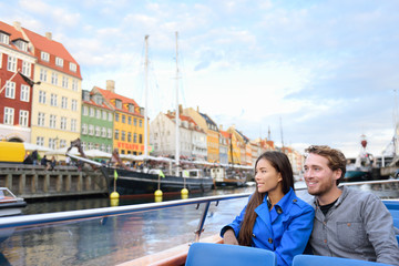 Copenhagen tourists people on cruise boat tour on water canal in old port Nyhavn. Young multiracial...