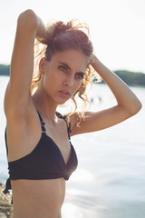 Girl at the beach holding hair up