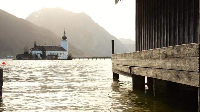 Lake Traunsee and Schloss Castle Ort in Upper Austria on a warm spring morning