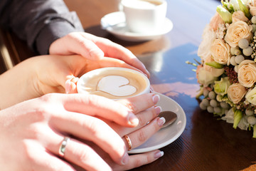 cup of coffee and hands newlywed
