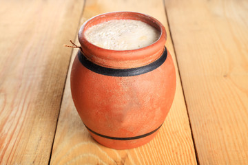Fresh cottage cheese in a jar on wooden board