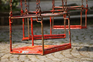 Old red wooden swings