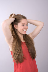 Fototapeta premium Portrait of a teenage girl with hands in her long hair
