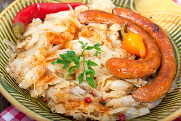 Close up of sauerkraut and sausages on vintage plate