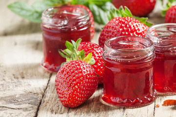 Strawberry confiture with whole berries and fresh strawberries o