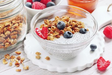Superfoods concept : overnight chia pudding with homemade granola,fresh berries and honey. Healthy eating. Selective focus