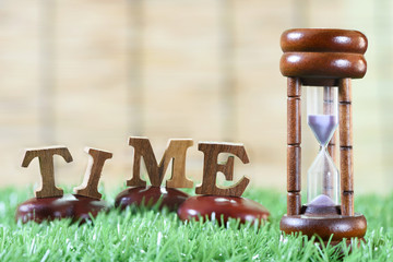 Sandglass and wooden alphabet, Time management concept and in time idea