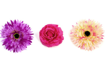 Floristics - droped artificial flowers on white background