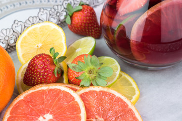 Pitcher of popular wine -based beverage - Sangria and slices of citrus fruits.