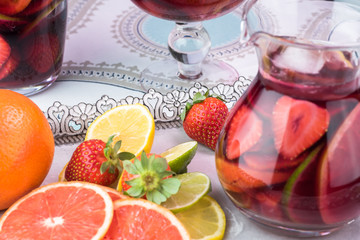 Pitcher of popular wine -based beverage - Sangria and slices of citrus fruits.