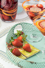Martini glasses with sangria and strawberries.