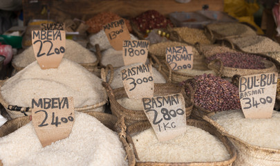 baskets with different rice sorts and price labels on market in zanzibar, tanzania
