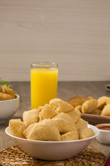 Pastel, a Brazilian snack, with a bar in the background. Cheese