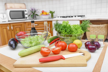 Preparation for slicing of salad in kitchen.