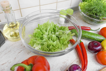 Preparation for slicing of salad in kitchen.