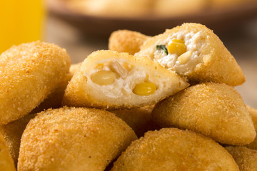 Rissole - Corn and cheese rissole served with chili sauce on woo