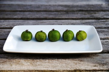 Mini baby kiwi berries on a wooden table
