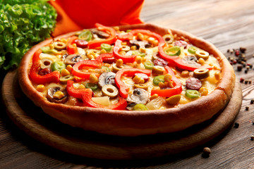 Delicious pizza with vegetables and meat, close-up
