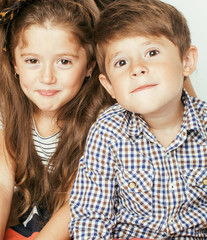 little cute boy and girl hugging playing on white background, happy family smiling