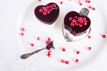 Valentine's cake in heart shape on white background with white decor