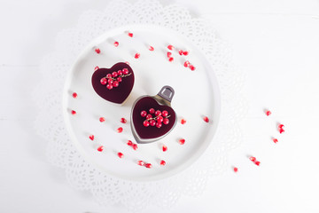 Valentine's cake in heart shape on white background with white decor