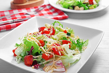 Tasty salmon salad on wooden table background