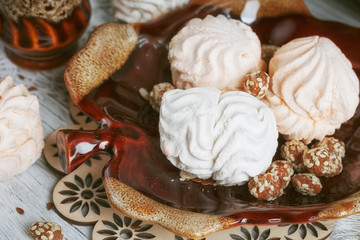 cups of coffee with a pussy willow, candies and a zephyr