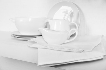 Tableware with napkin on a white background, close up
