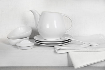 Tableware with napkin on a white background