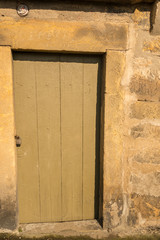 Obraz na płótnie Canvas old wooden door in a sandstone wall