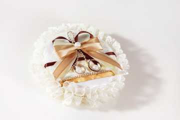 Fototapeta na wymiar Closeup image of beautiful cushion with two golden wedding rings