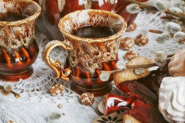 cups of coffee with a pussy willow, candies and a zephyr