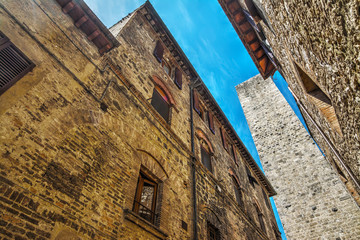 narrow street and medieval tower in San Gimignano