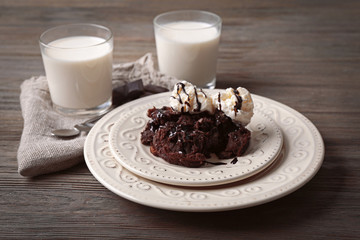 Served table of chocolate lava cake with ice-cream and milk