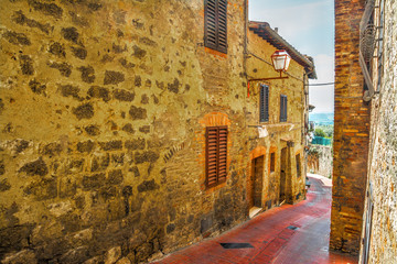 brick facade in a narrow street in San Gimignano
